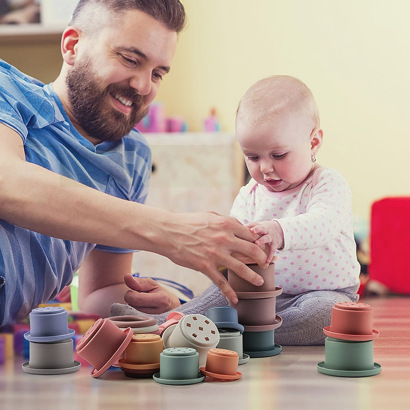 Father and baby playing with a BPA free Silicone Stackable Bowls toy set