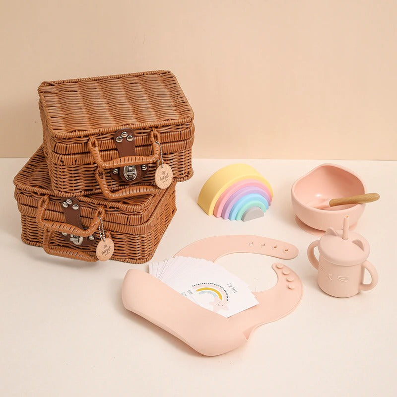 Pink bundle of silicone toys and feeding accessories for the new baby.