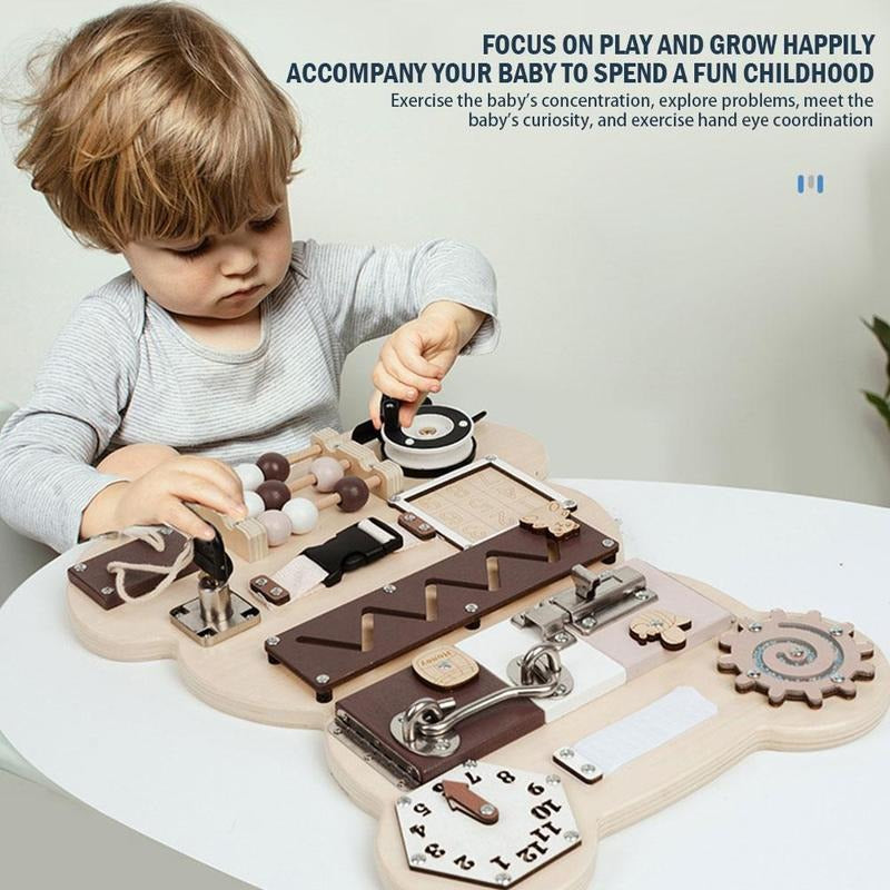 A toddler playing with a bear busy board